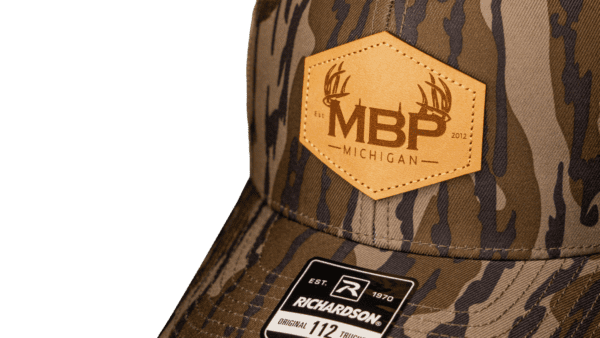 camo baseball cap leather logo up close shot