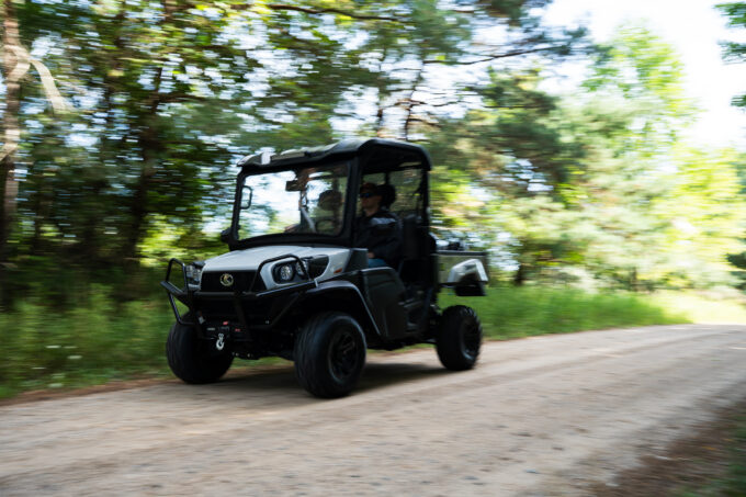 Kubota Sidekick driving down road